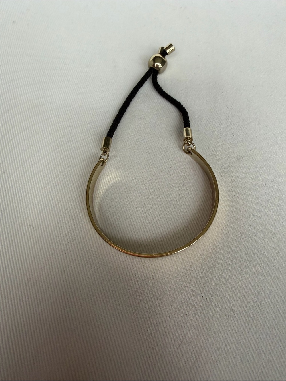 Gold Tone Adjustable Bracelet with Black Cord